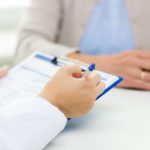doctor recording medical info in chart